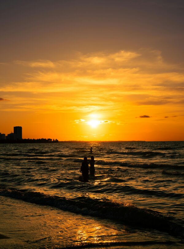 A beautiful silhouette against the breathtaking sunset over Coveñas beach, Colombia.